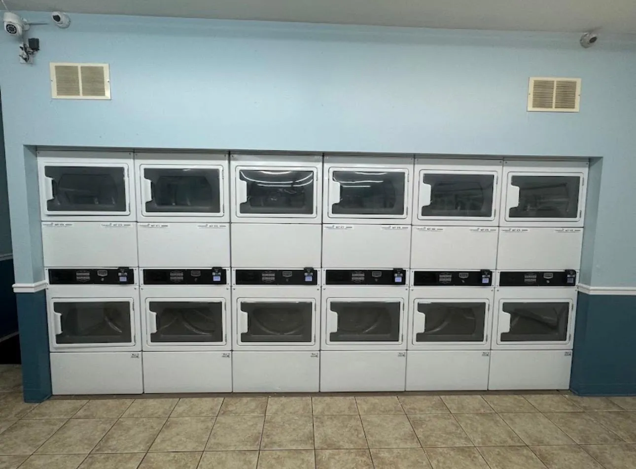A wall of stacked double dryers.
